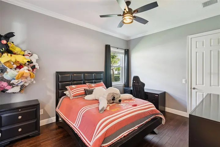 Bedroom TwoComfortable secondary bedroom sharing a Jack-and-Jill bathroom with Bedroom Three. A built-in desk area is conveniently located just outside the bedrooms.