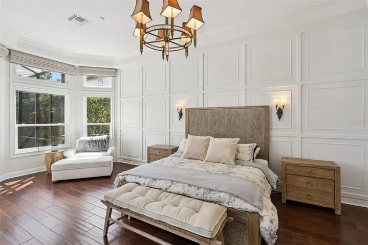 Primary BedroomPrivate primary suite with serene views, custom window treatments and beautifully renovated walk-in closets.Primary ClosetsCustom California Closets built-ins and updated flooring create stylish and organized storage.