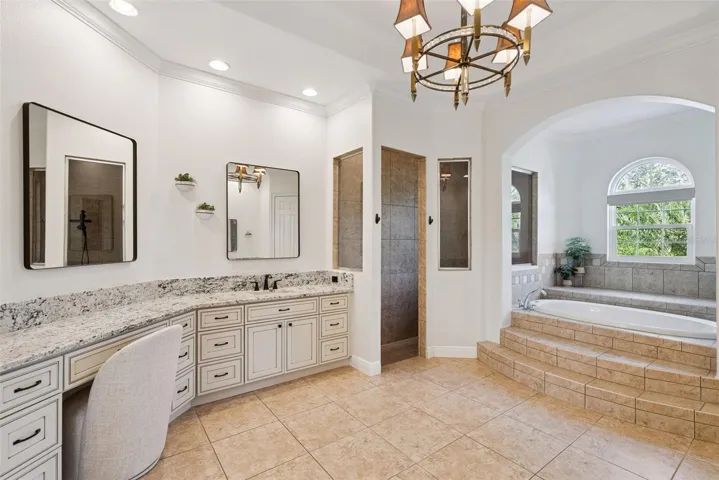 Primary BathroomSpacious primary bathroom with updated countertops, sinks and cabinetry in both vanity areas.