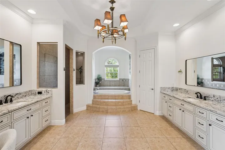 Primary BathroomSpacious primary bathroom with updated countertops, sinks and cabinetry in both vanity areas.