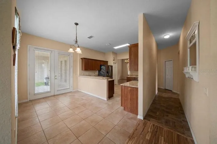 Kitchen/ Hallway to two of the four bedrooms Virtually Staged