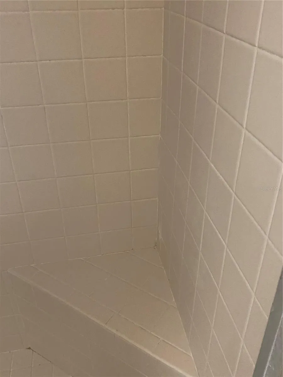 Guest bathroom showder with bench area.