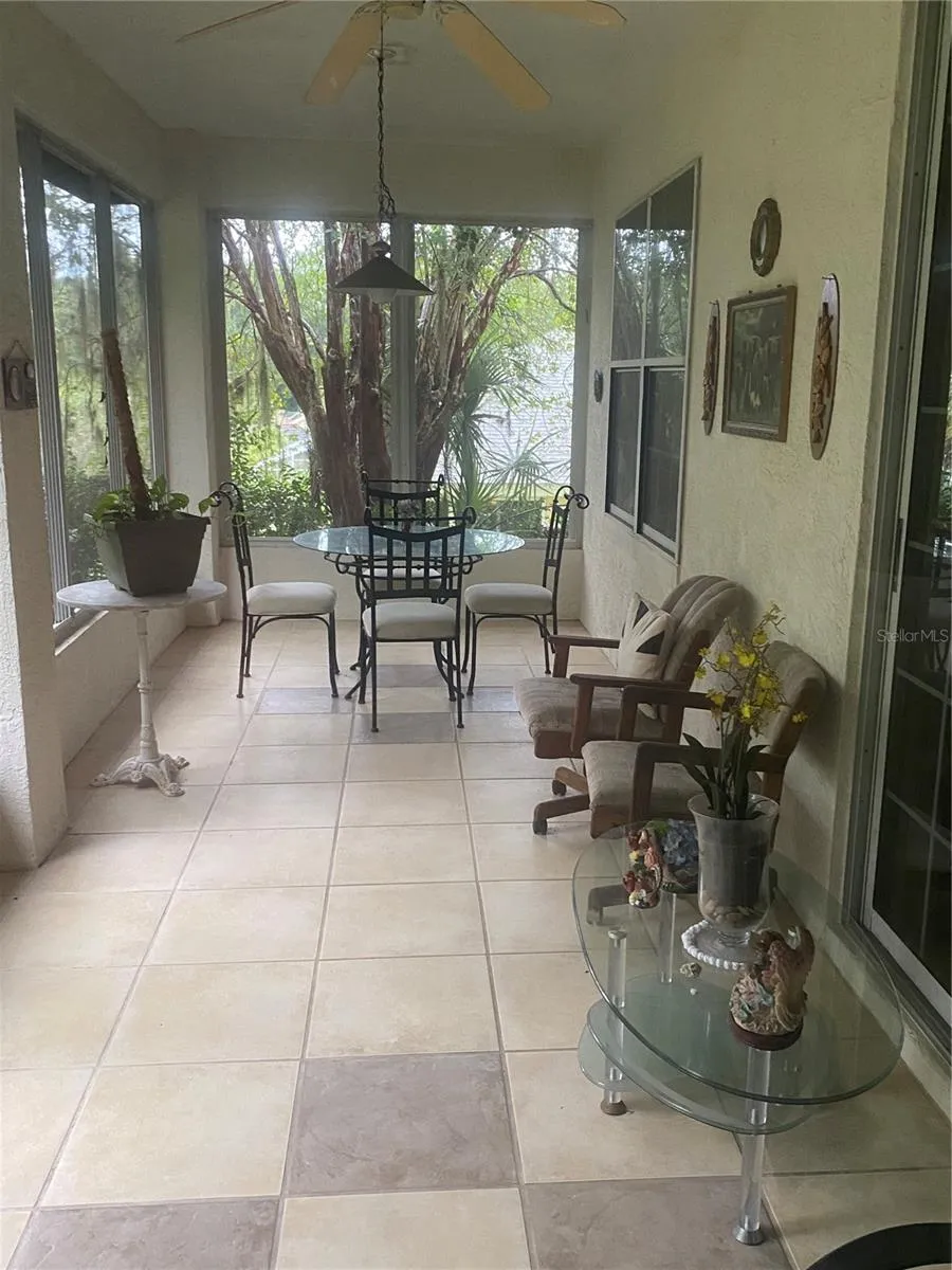 Screened in lanai facing the backyard with tiles flooring