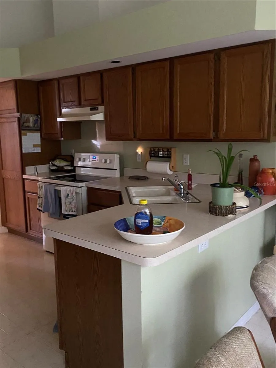 Large kitchen with cabinets and a lot drawers with pantry.