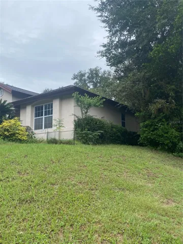 Side of the house, on a hill.