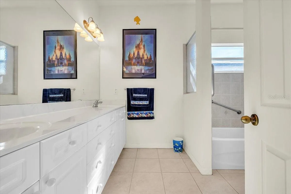 Bathroom 2 has dual sinks, tub with shower