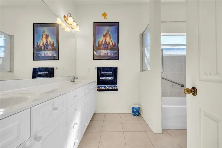 Bathroom 2 has dual sinks, tub with shower