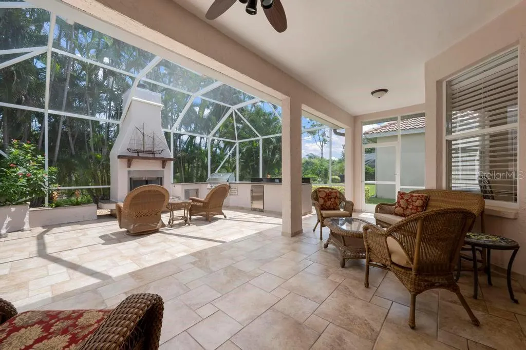 Screened and underroof lanai, tile floor, working wood burning fire place, outdoor kitchen