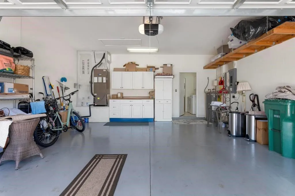 Deep two car garage with built-in cabinets and storage
