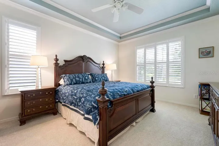 Primary Bedroom with tray ceiling and plantation shutters