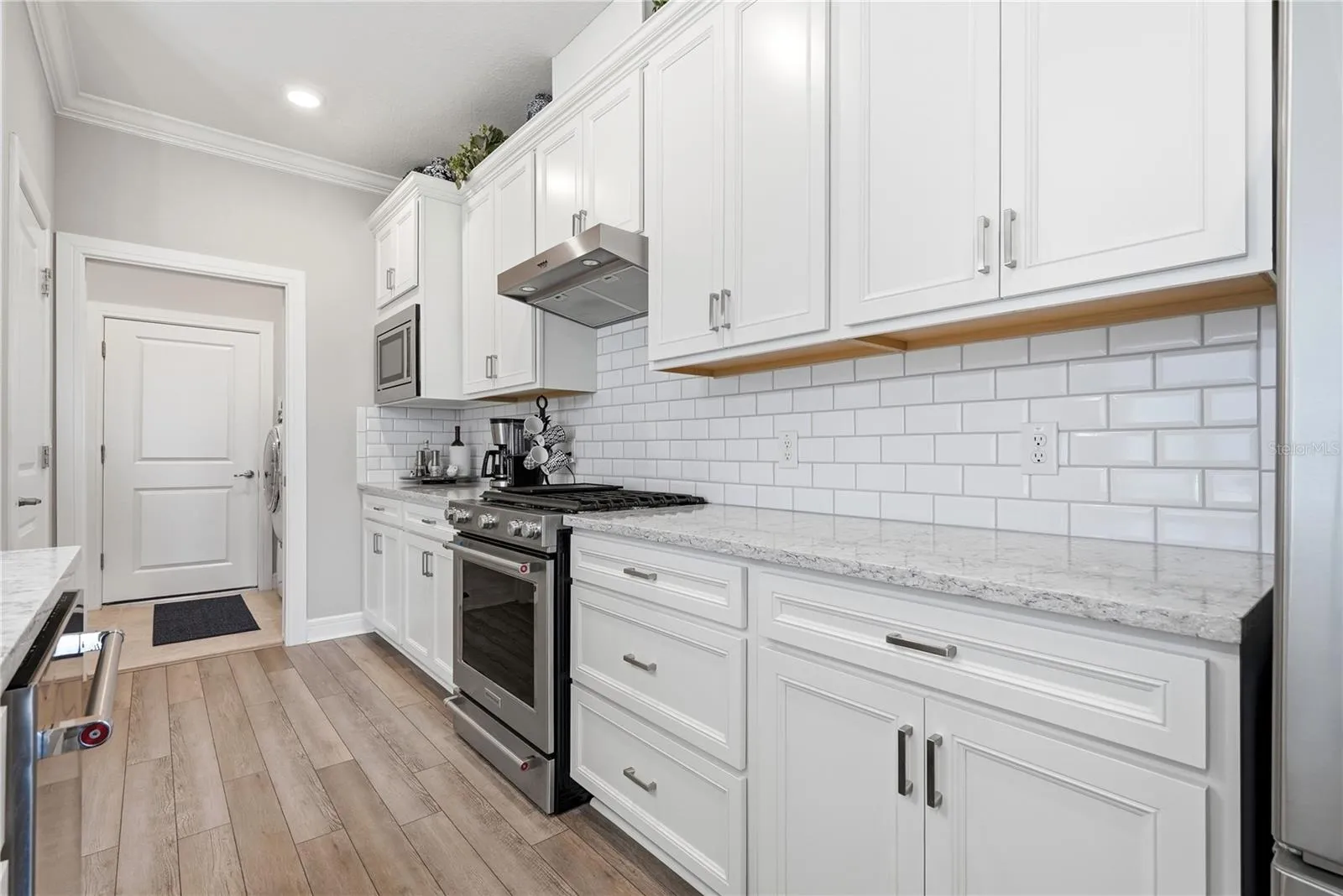 Enjoy cooking with a 5 burner gas stove. Cabinetry has easy pull out shelving.