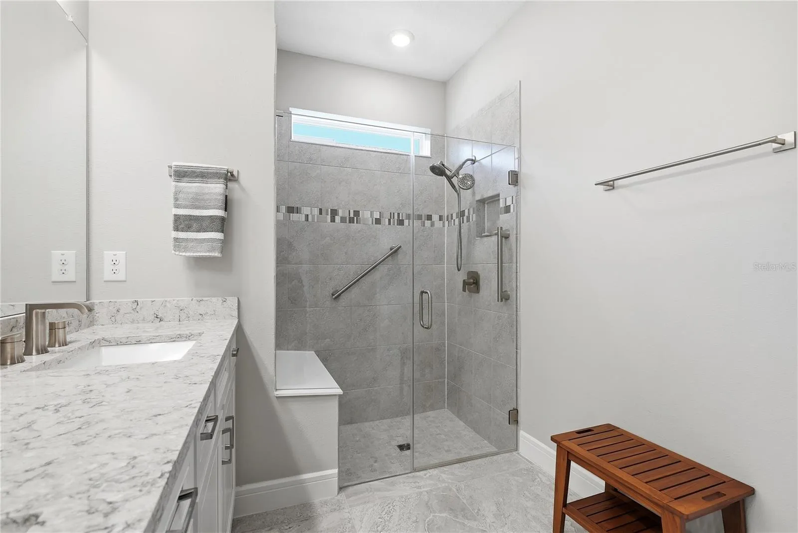 Primary Ensuite with walk in shower and grab bars.