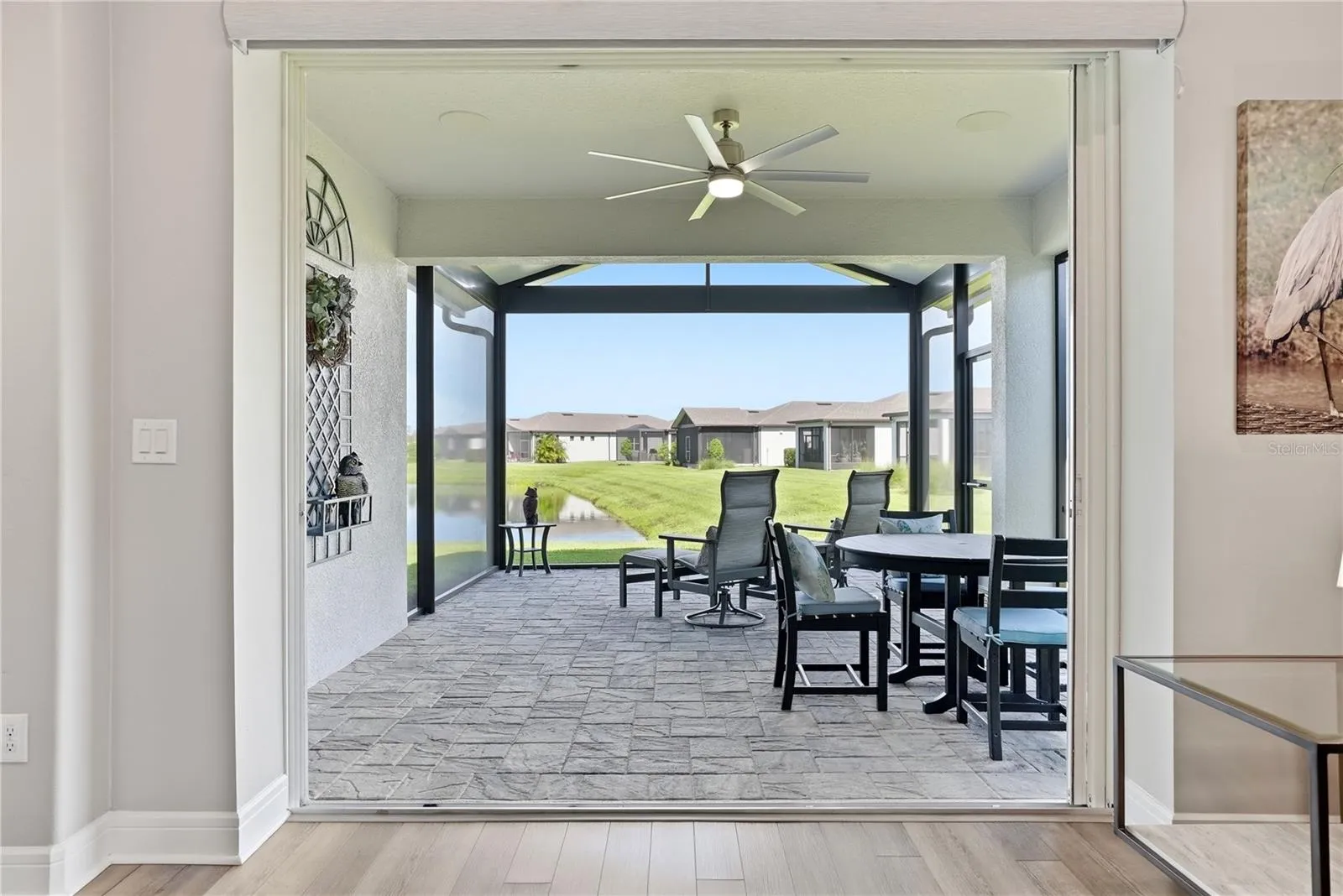 Relax in the covered and screened in lanai with a pond view.