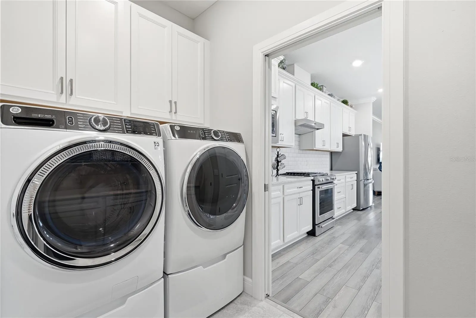 Front Loaders Washer and Dryer on pedestals with storage.