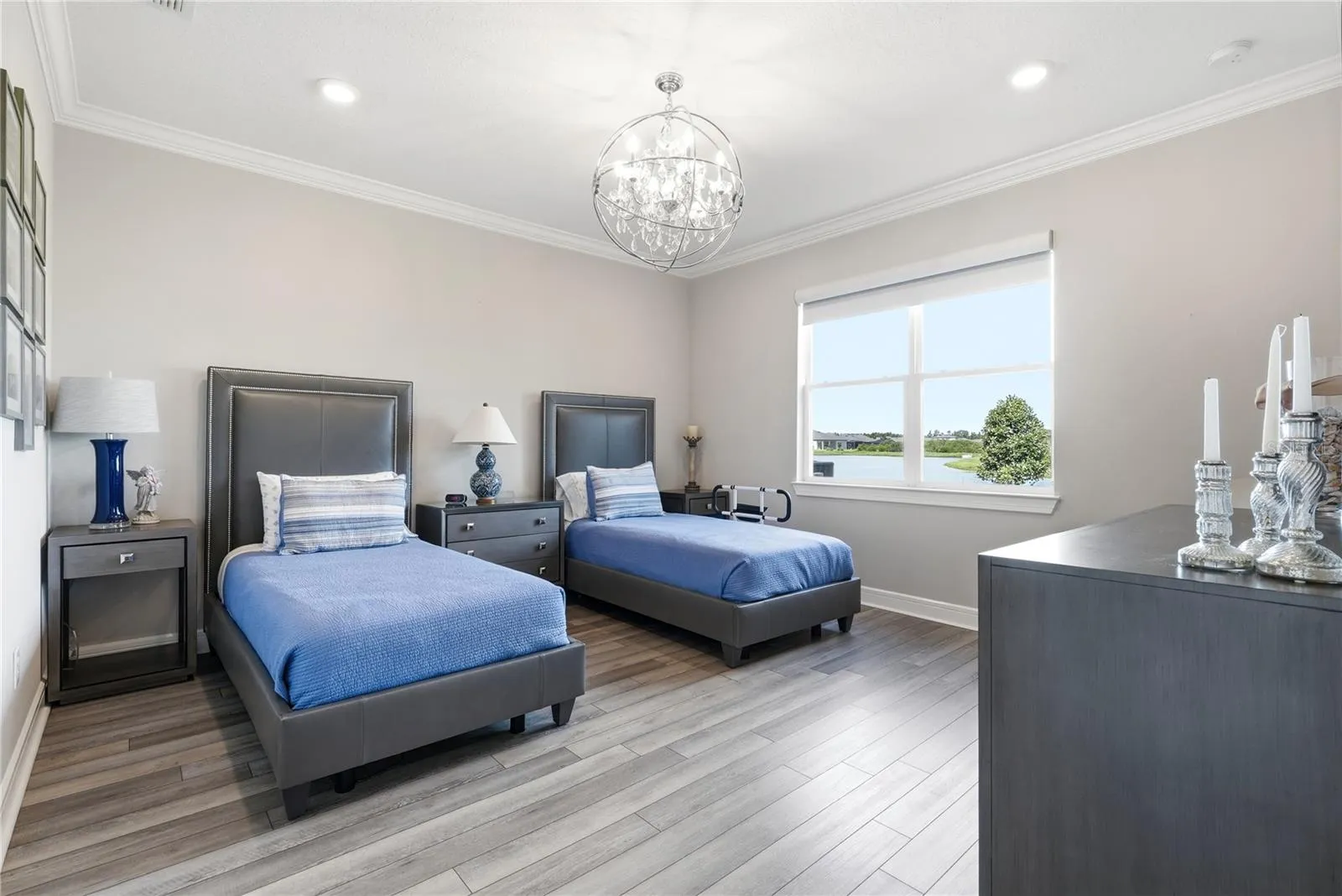Primary Bedroom with a water view and a gorgeous chandelier.