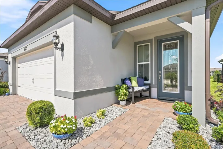 Pavers extend from the driveway to the covered front door.