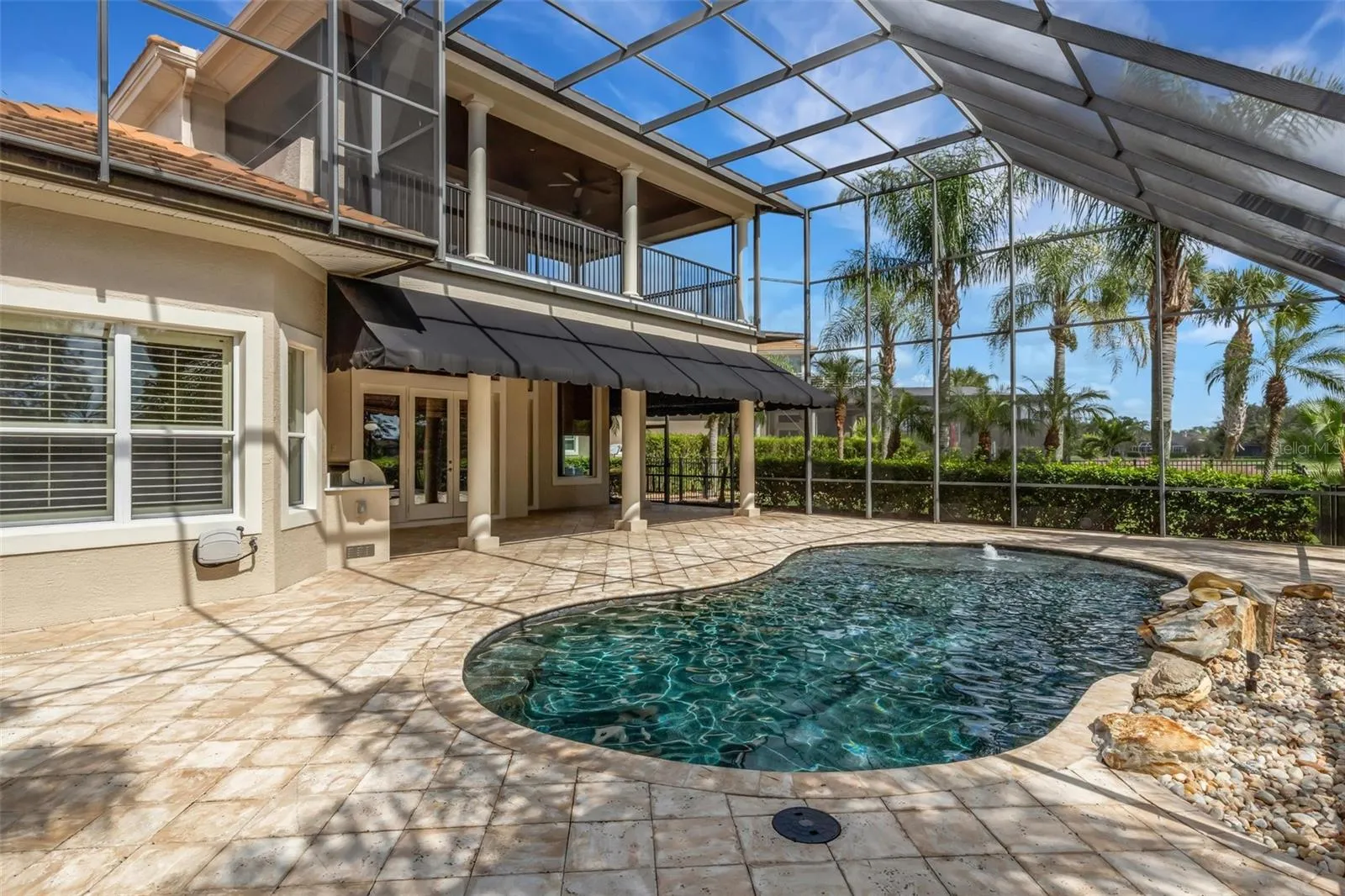 Lagoon inspired pool complete with beach area and rock water feature.