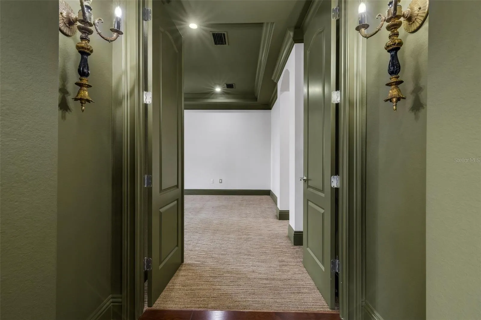 The primary suite is on the first floor and secluded away through double doors.