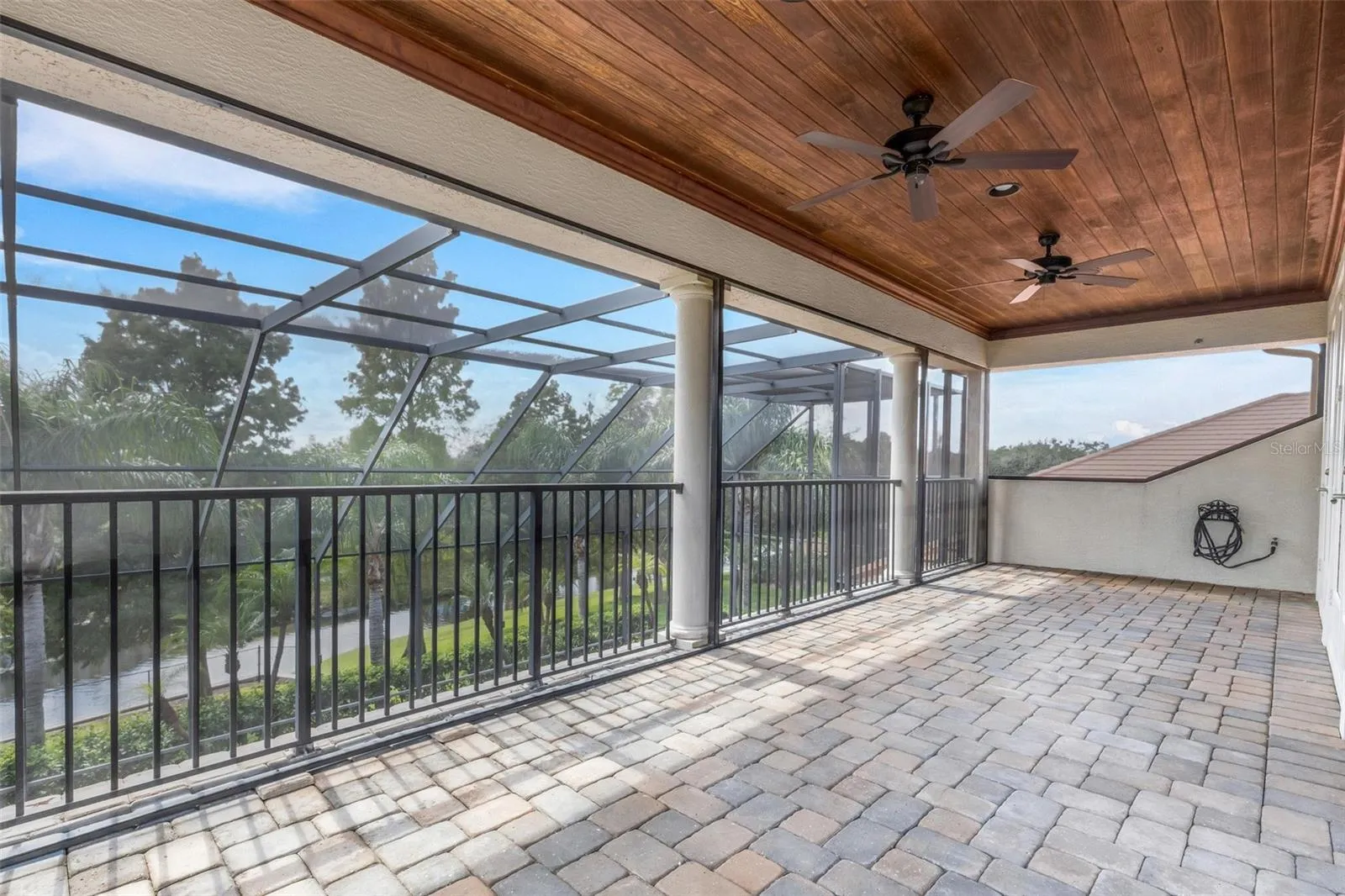 With wood ceiling above and brick pavers under foot.