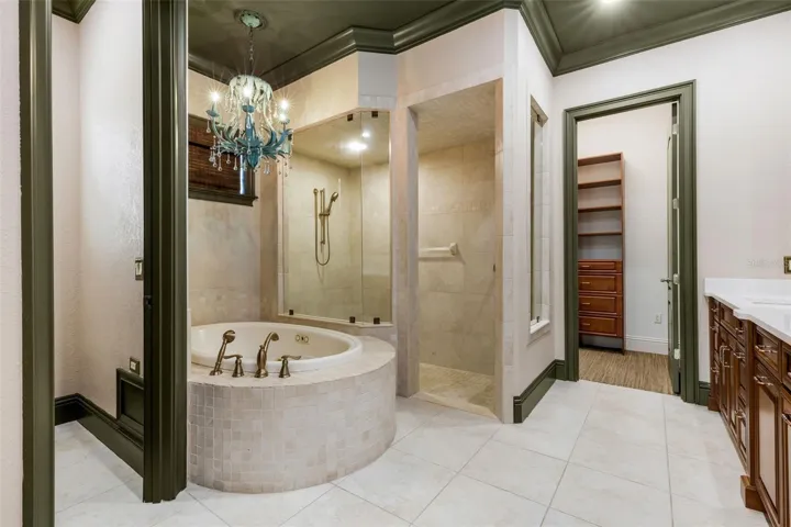 The deep jetted tub and fully tiled walk-in shower.