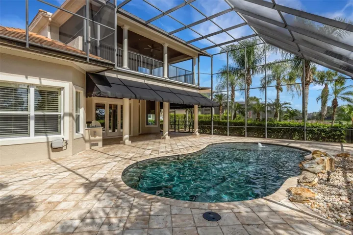 Lagoon inspired pool complete with beach area and rock water feature.