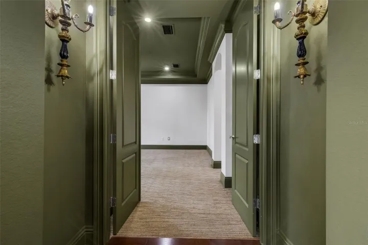 The primary suite is on the first floor and secluded away through double doors.