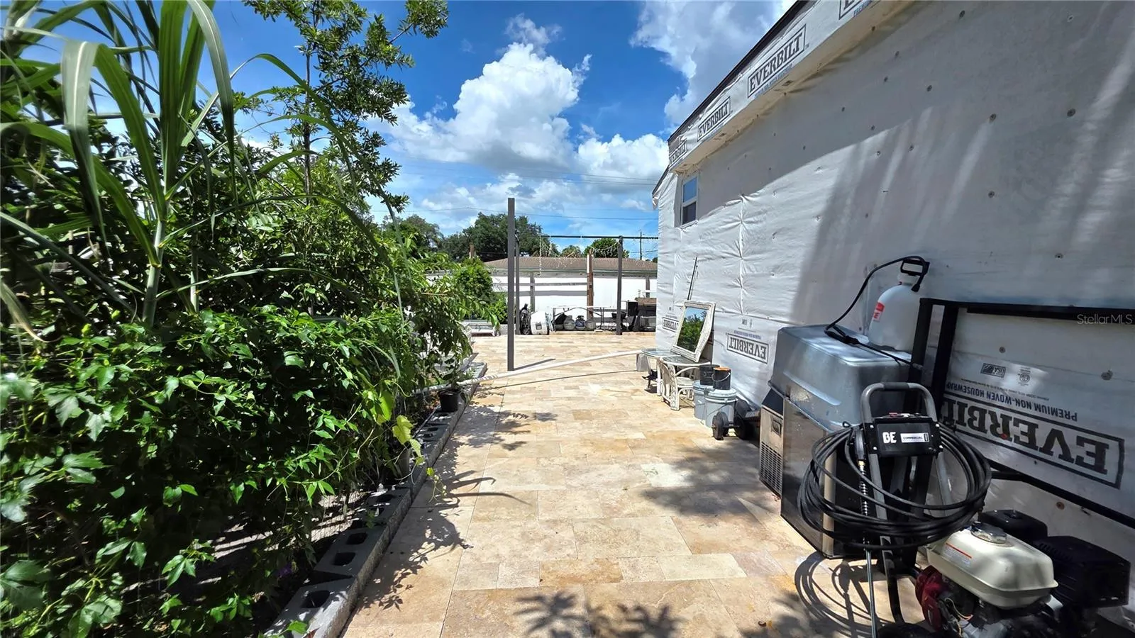 View from Behine Home, Garden Area, Tiled/Pavered Back Patio. Note - Addition being added to home will need to be removed.