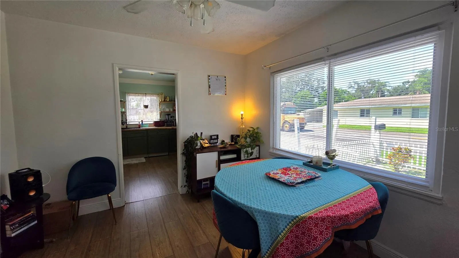 Dining/Flex Room with Ceiling Fan, Laminate Flooring, and Windows overlooking Side Yard