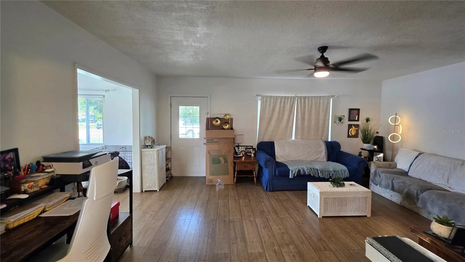 Living Room with Ceiling Fan, Laminate Flooring, and Window overlooking Front Yard, Front Door Entry