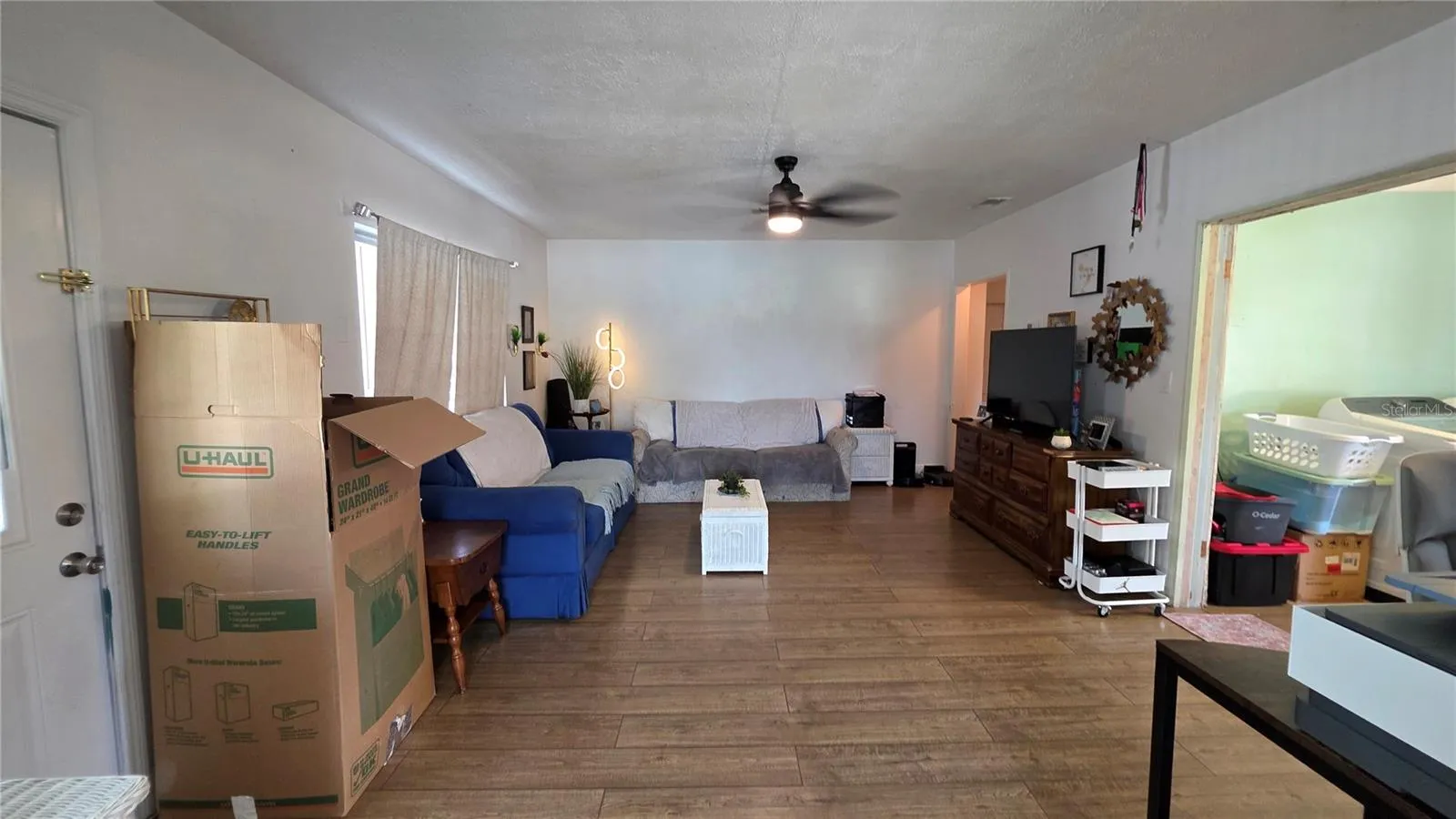 Living Room with Ceiling Fan, Laminate Flooring, and Window overlooking Front Yard