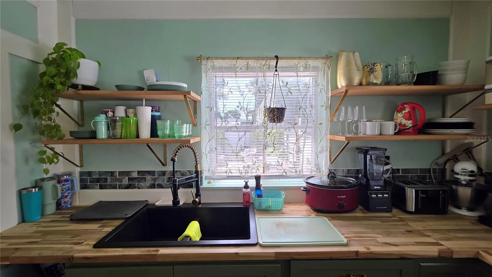 Undermount Sink, Decorative Shelving, Window overlooking Back Patio