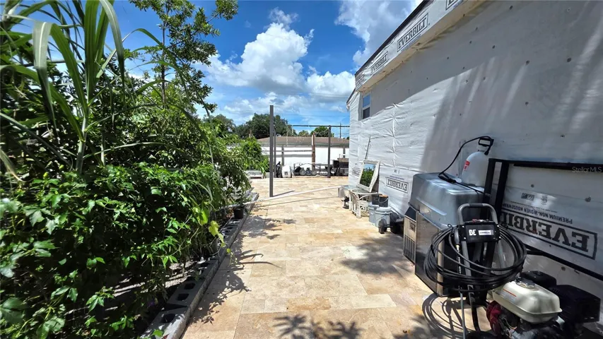 View from Behine Home, Garden Area, Tiled/Pavered Back Patio. Note - Addition being added to home will need to be removed.