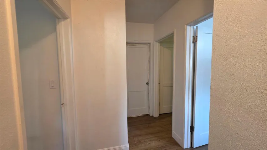 Hallway and Doors to Primary, 2 Bedrooms, and Full Bathroom (non-functional)