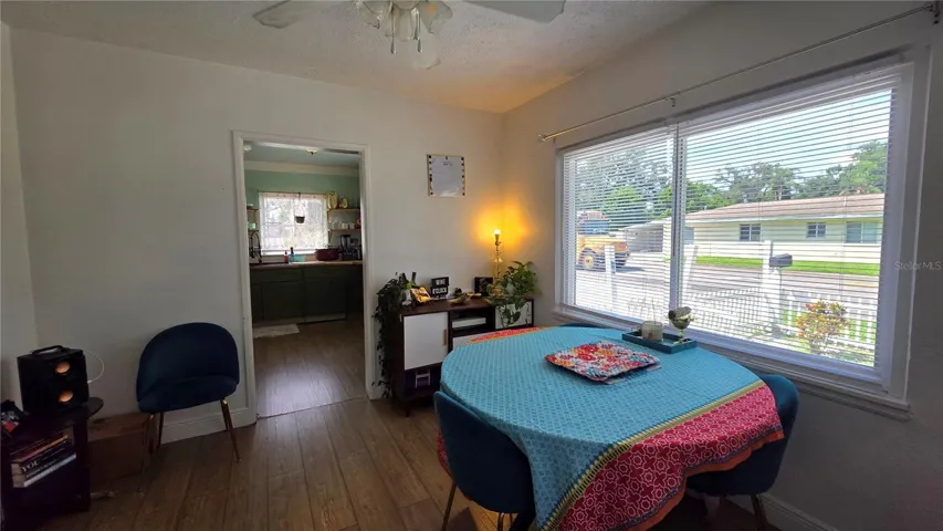 Dining/Flex Room with Ceiling Fan, Laminate Flooring, and Windows overlooking Side Yard