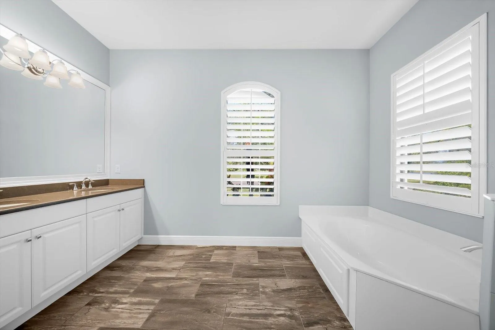 Primary Bathroom with Dual Sinks and Tub