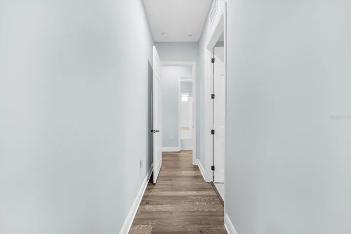 Hallway to Laundry Room, Garage and 2nd & 3rd Bedrooms and 2nd Bath