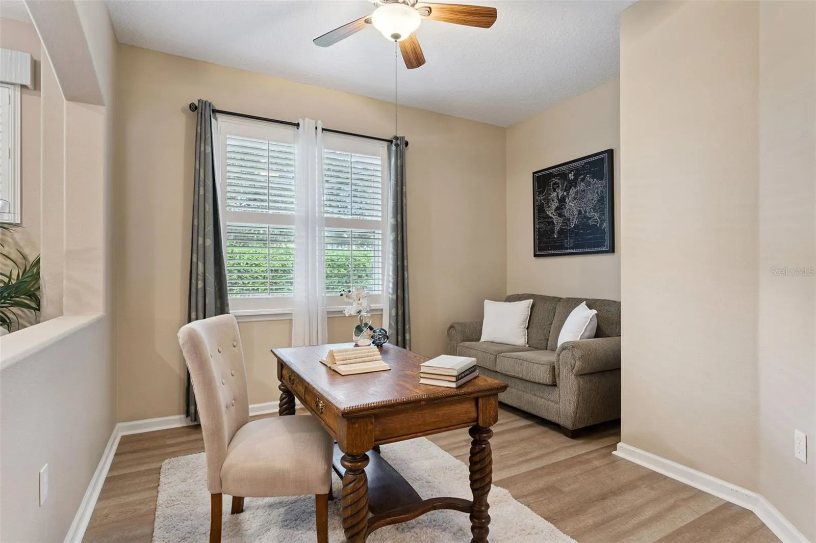 11' x 12' Den/office w/ luxury vinyl flooring & a ceiling fan
