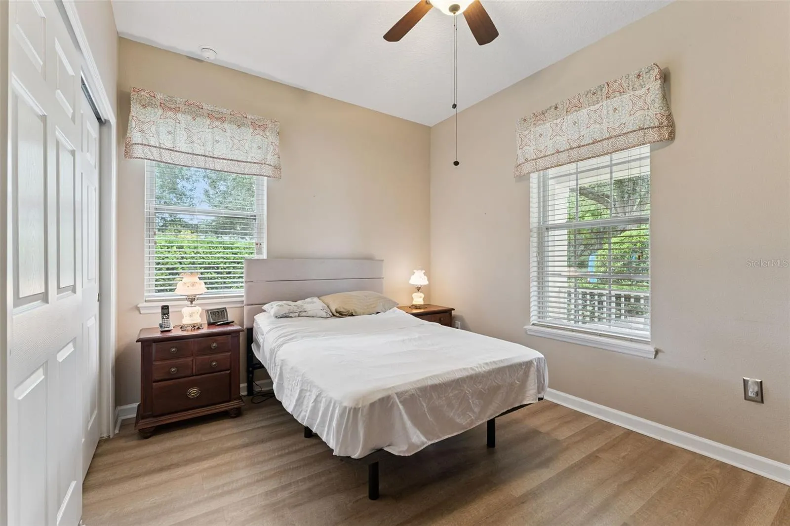 12'6" x 10' Bedroom #2 w/ a luxury vinyl floor & a ceiling fan