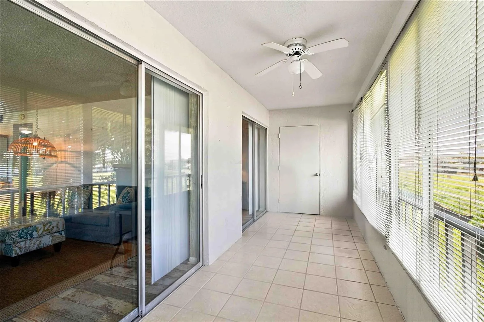 Large rear balcony, enclosed. Some storage totes were removed from the image.