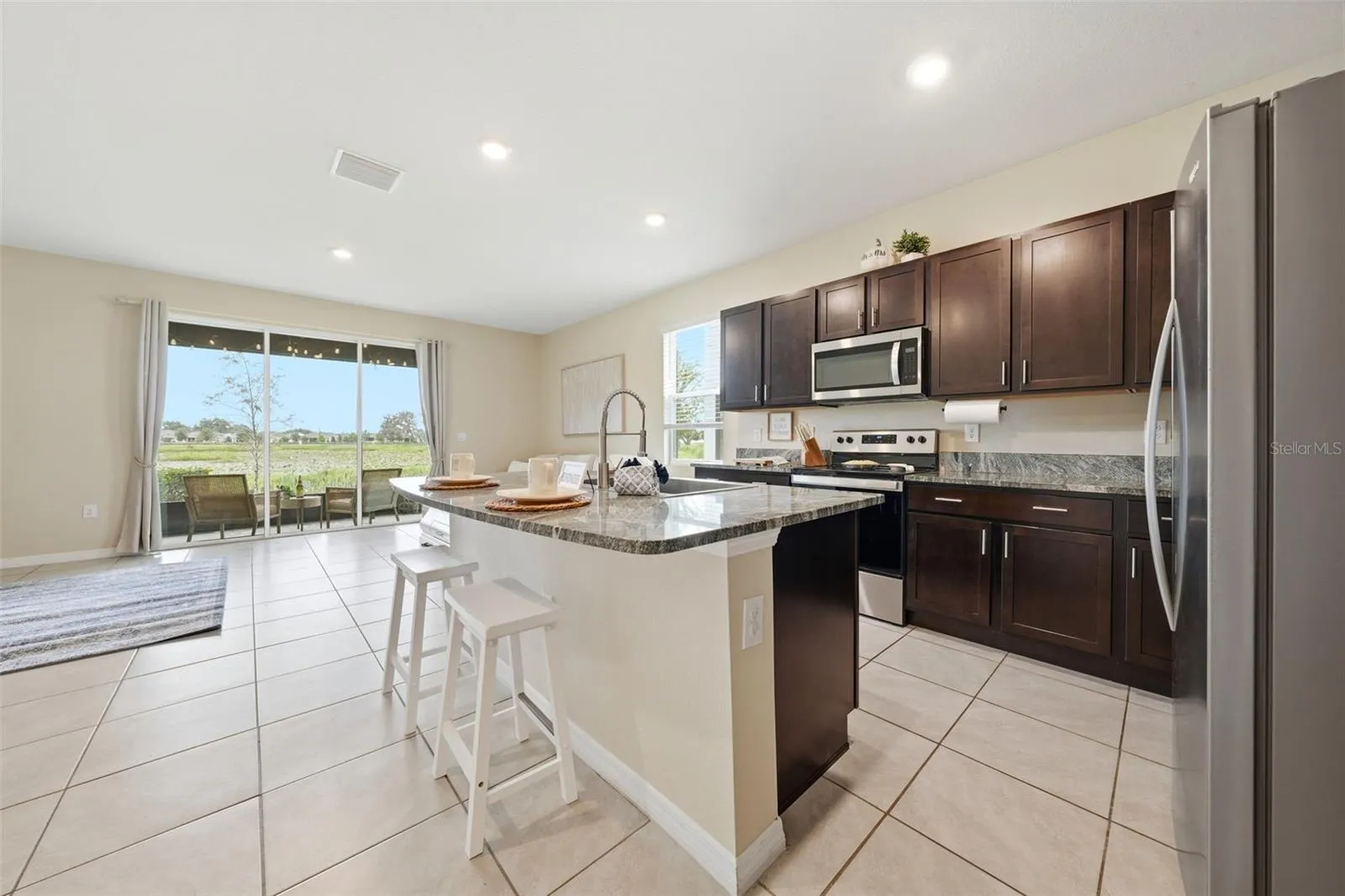 Kitchen has an abundant amount of cabinets, stainless steel appliances, deep single-basin kitchen sink and a waterfall sink!