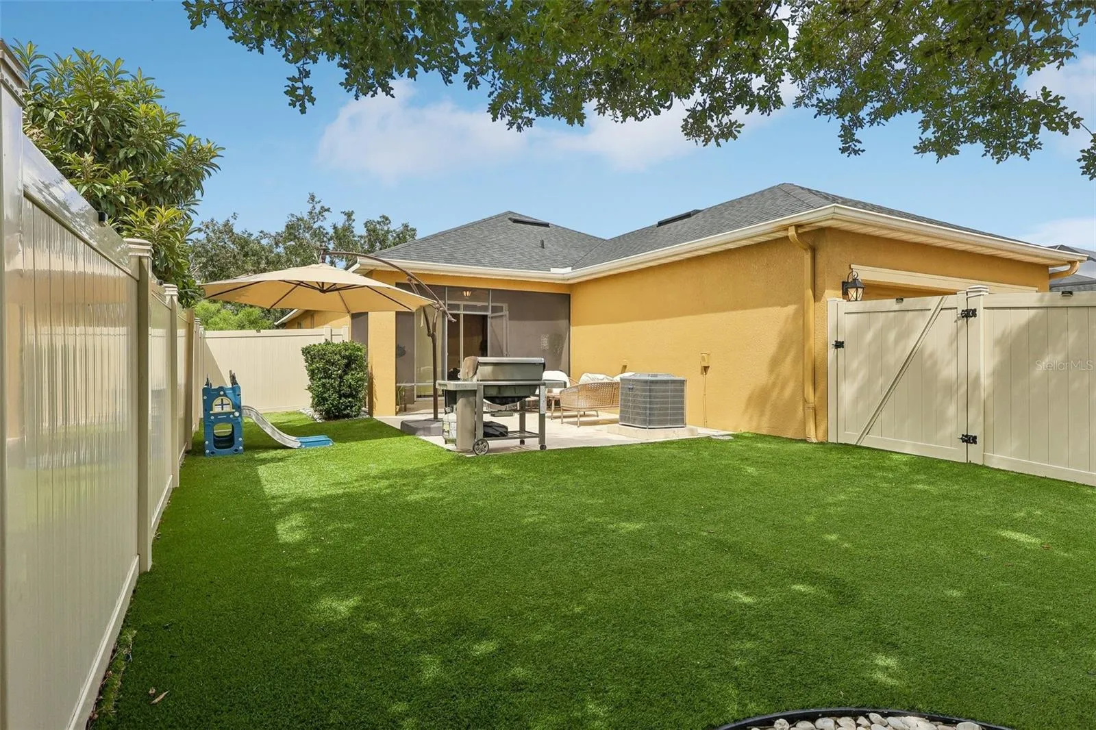 Backyard renovated with travertine &amp; pet friendly turf
