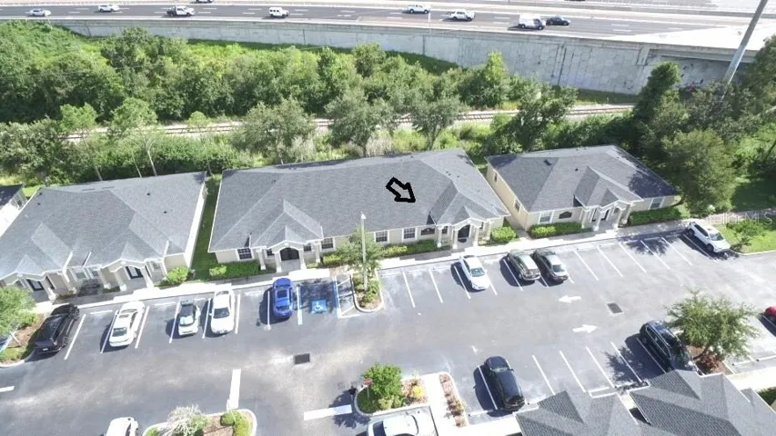 Aerial of 2 unit building. Arrow points to available 1500 sq. ft. unit on right side of building