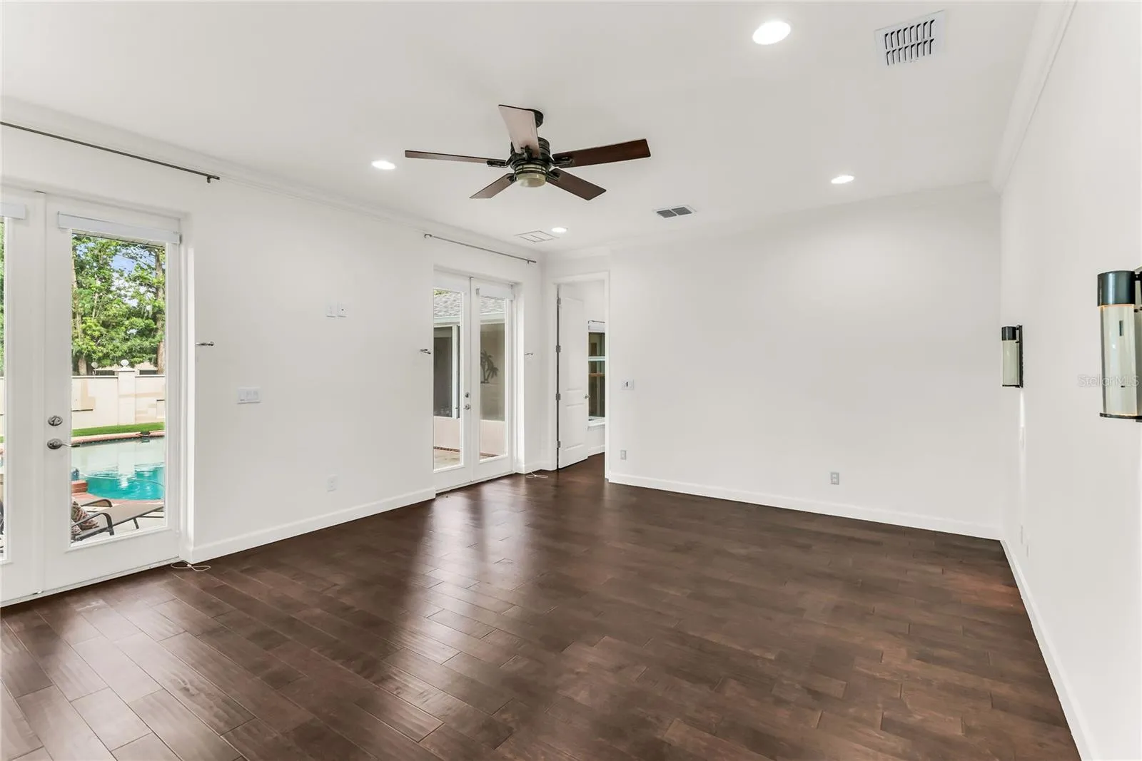 Primary Bedroom French doors lead outside to pool