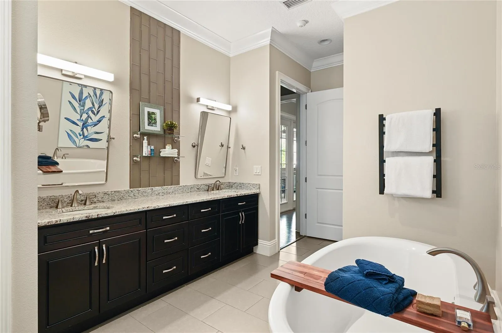 The master suite features 8-foot doors, a large linen closet, double sinks as well as dual shower heads and a hard-wired towel warming rack.