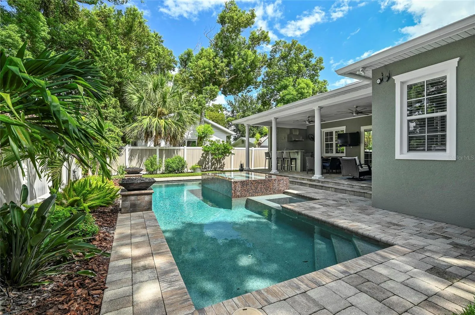 The salt water pool features a heated spill-over spa and paver deck.