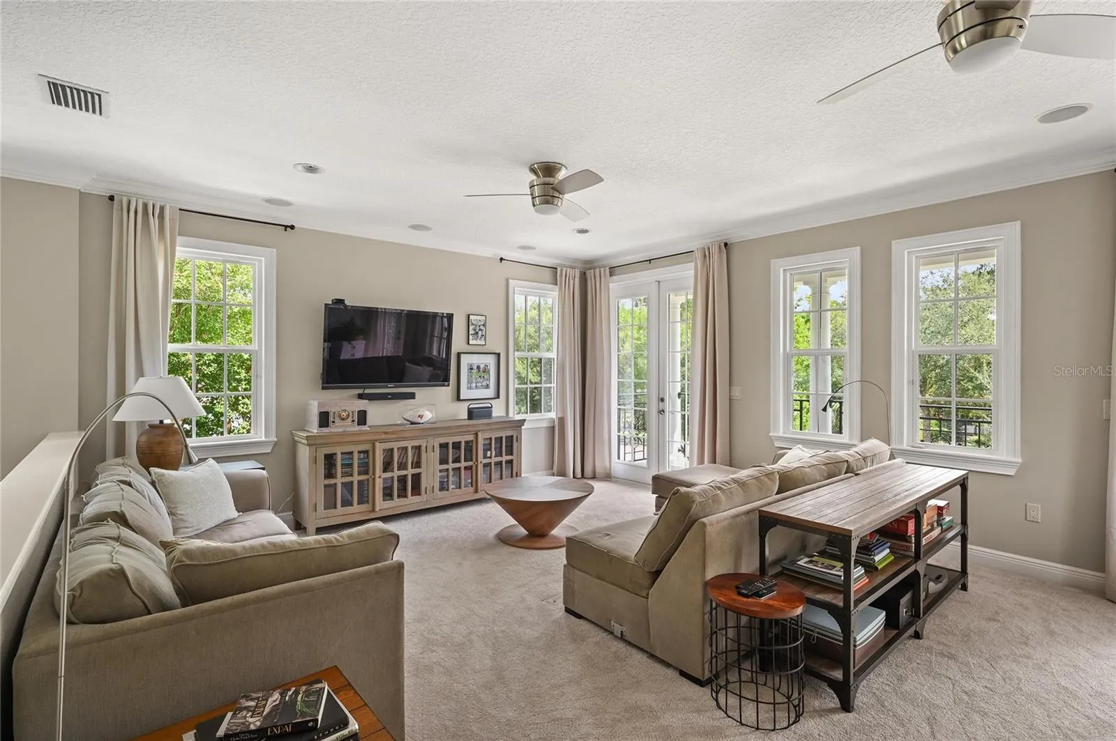 Double french doors let the light in and show off the surrounding tree canopy.