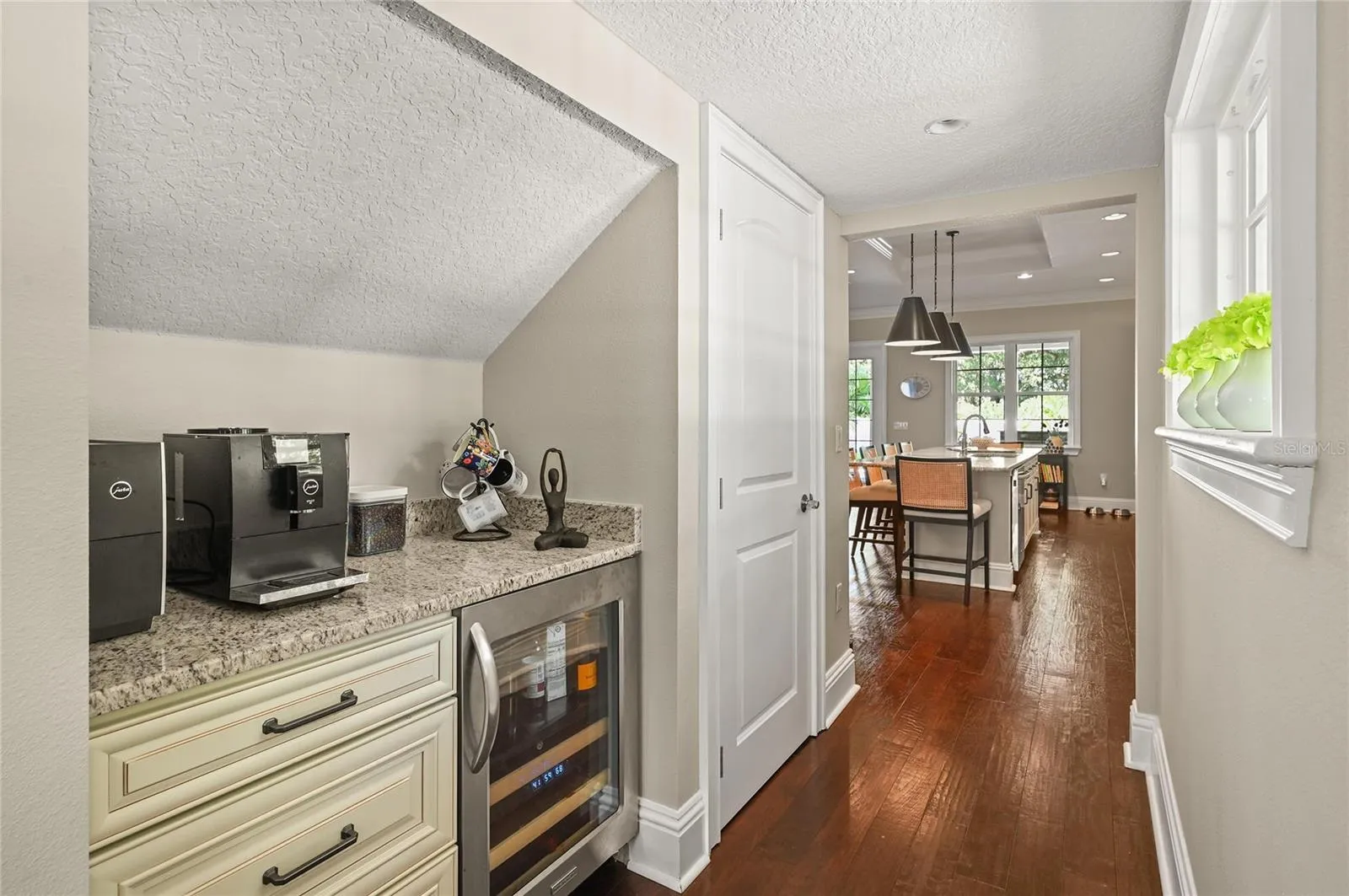There is a coffee bar and wine fridge tucked in next to the kitchen.