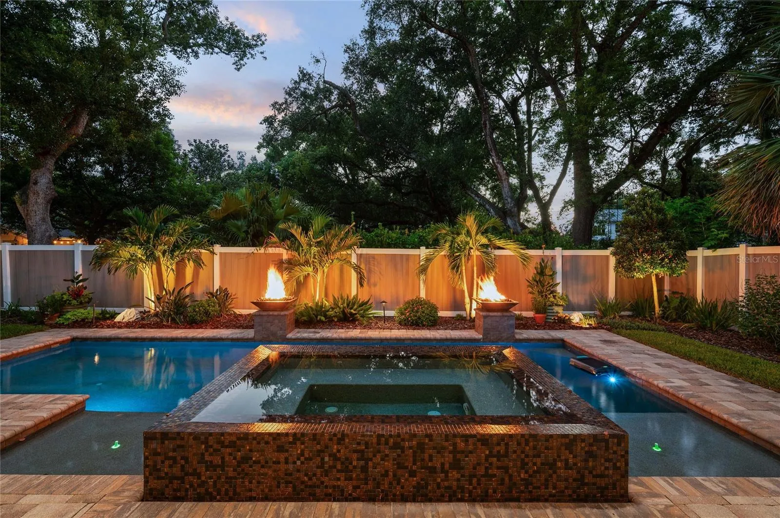 Twilight is magical overlooking the spill-over spa with gas firepits.