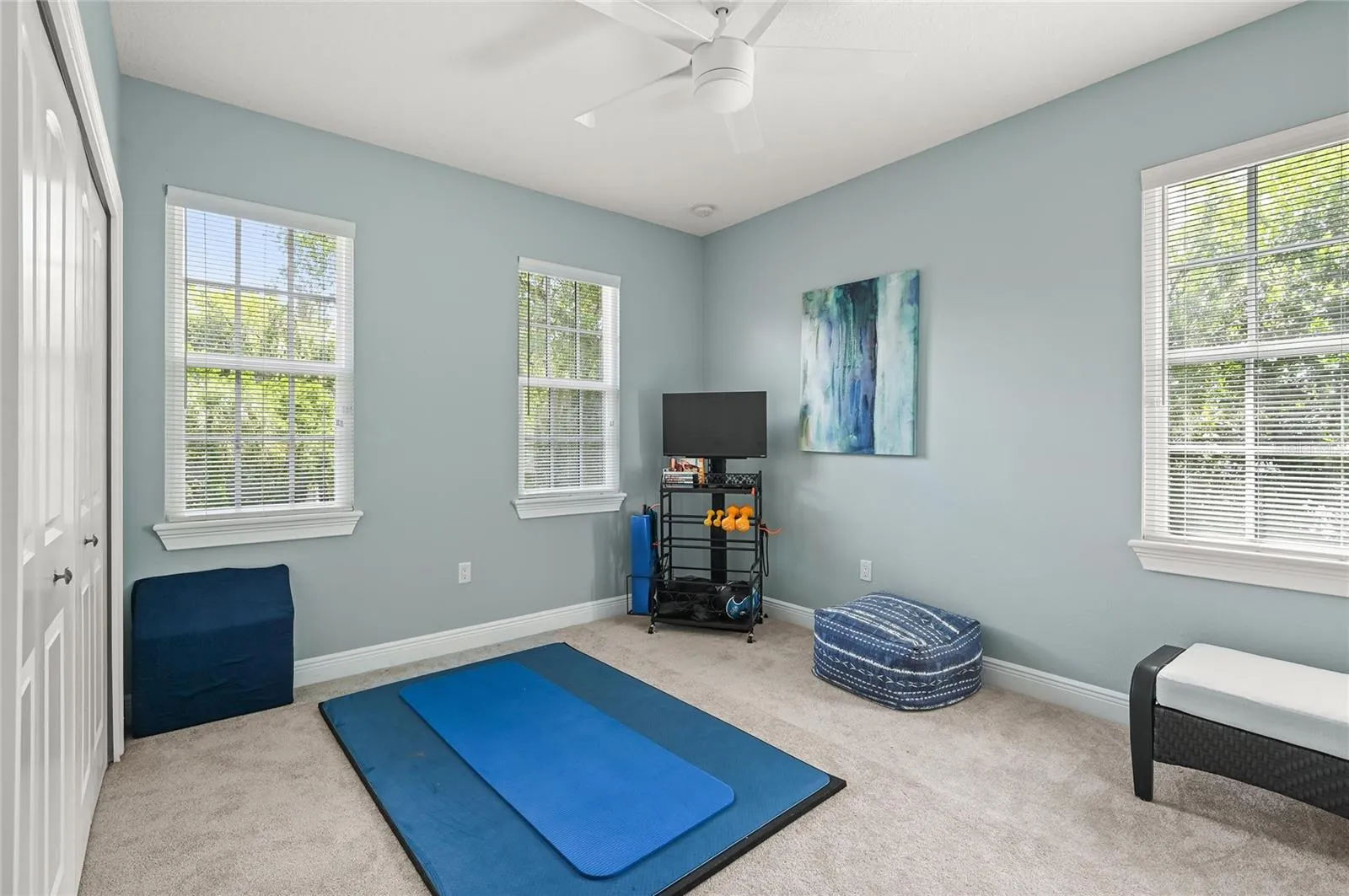 Currently used as an exercise room, this bedroom has some of the nicest morning light, and plenty of room for bedroom furnishings or an office.