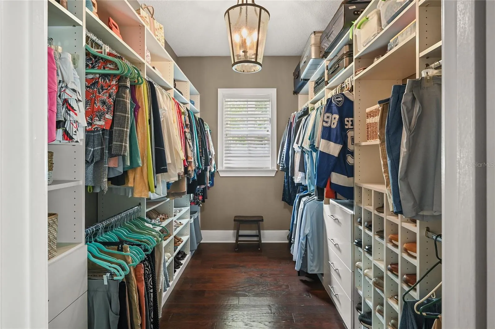 Another space made large by the natural light, high ceilings, and organizers, the primary closet checks all the boxes.